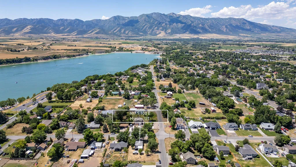 Aerial perspective showcasing a residential area with a prominent body of water and distant mountains