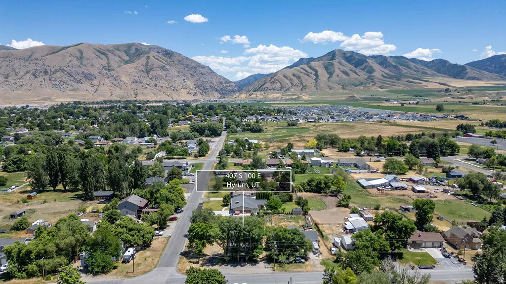 Expansive aerial panorama showcasing a residential area with varied housing styles and abundant mature trees