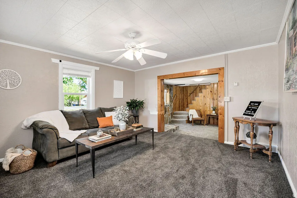 Living area featuring neutral wall paint and gray carpeting
