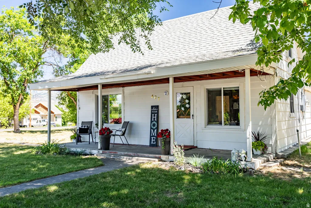White siding exterior with a covered front porch supported by columns