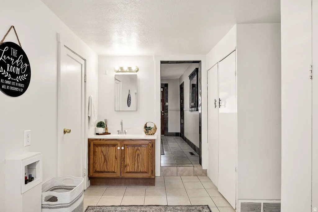 Oak-finish vanity with white countertop and integrated sink