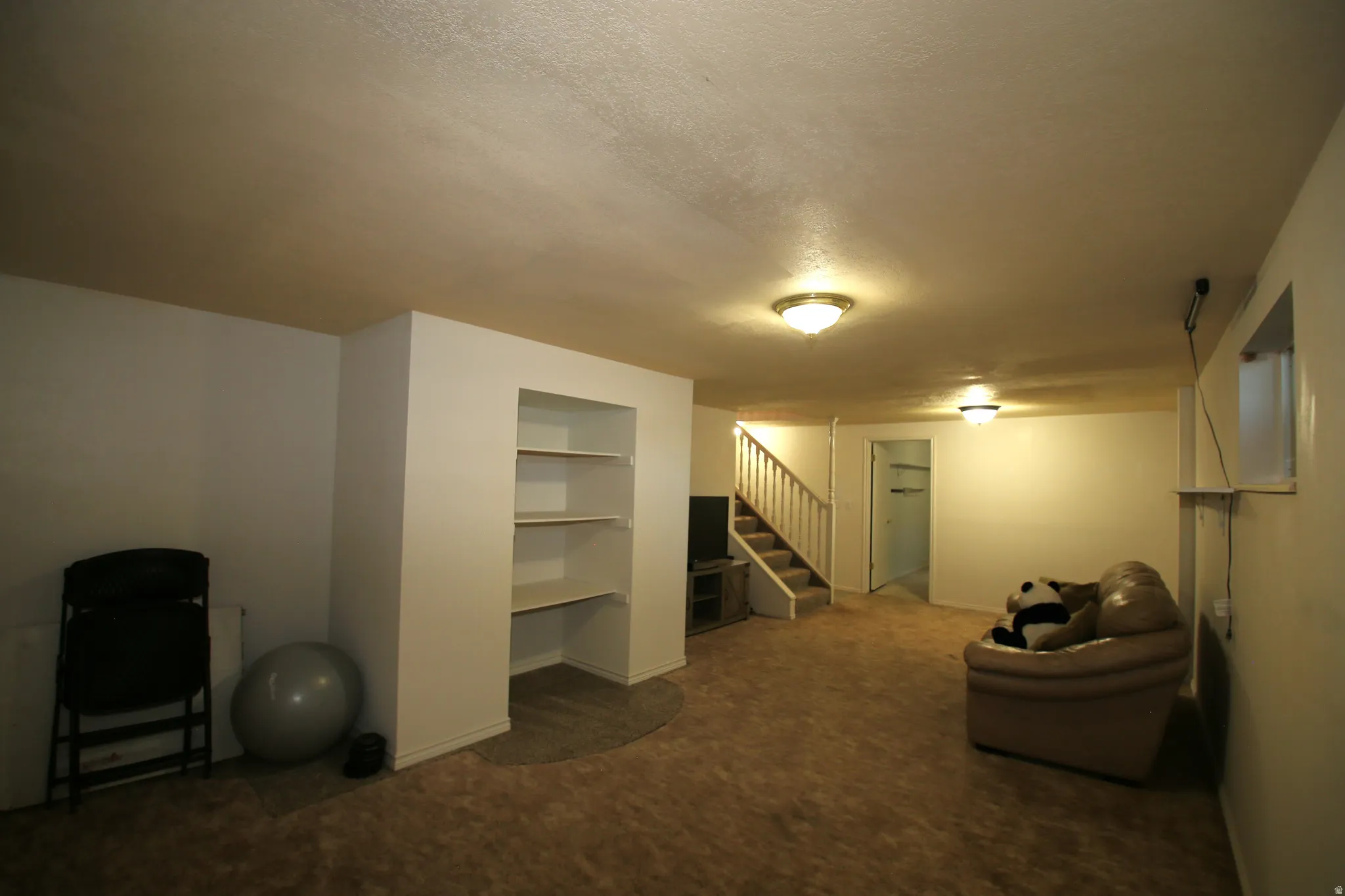 Spacious lower level featuring wood-finish flooring and recessed lighting