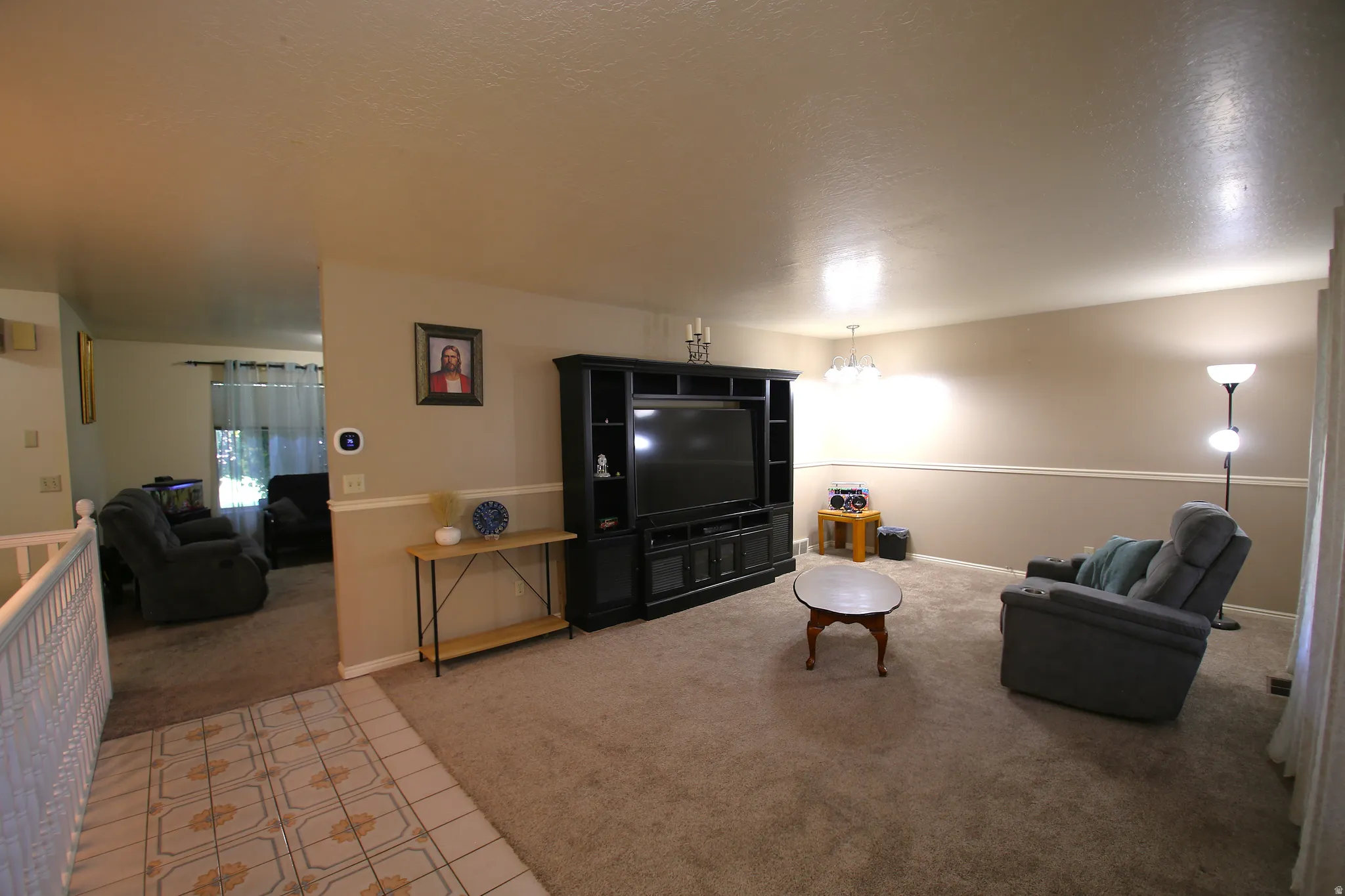 Carpeted living area with two-tone wall paint and a chair rail