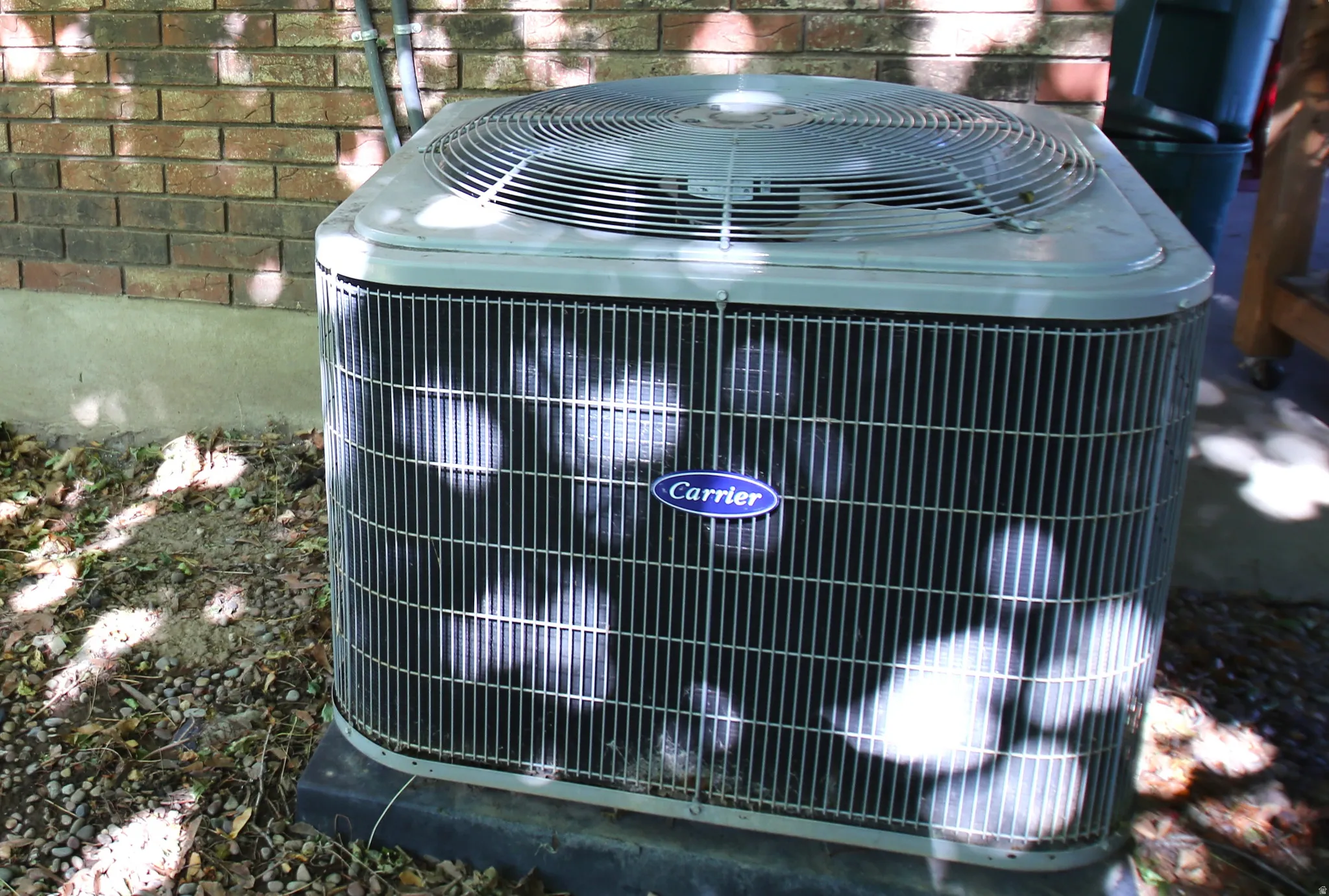 Exterior air conditioning unit featuring a Carrier brand emblem