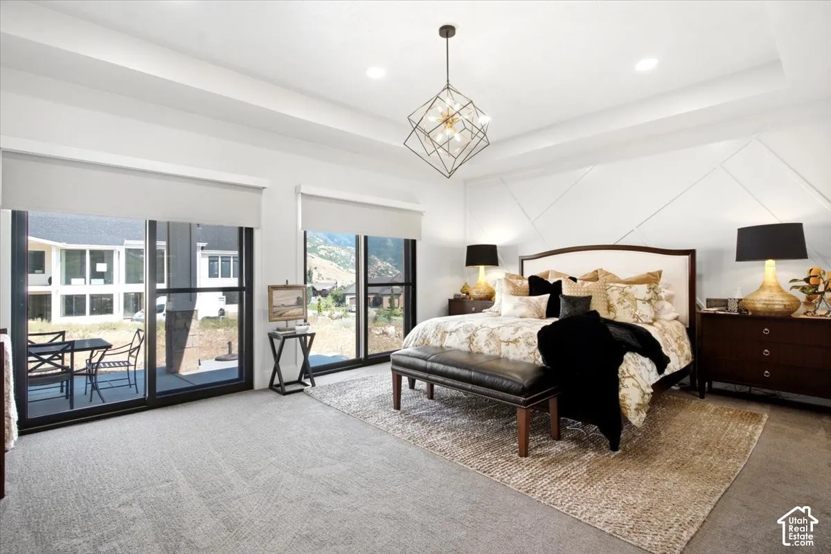 Spacious room featuring a decorative accent wall, recessed lighting, and a contemporary chandelier