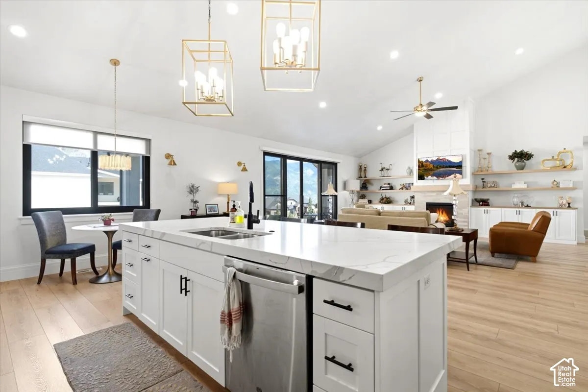 Expansive kitchen island with a stone-finish countertop, undermount sink, and integrated dishwasher