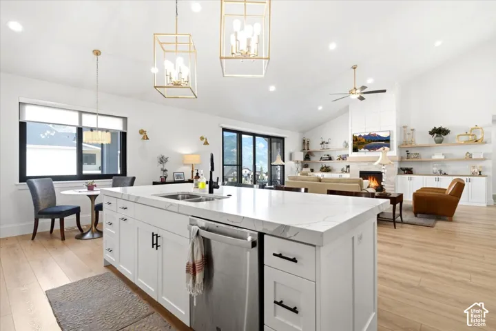 Expansive kitchen island with a stone-finish countertop, undermount sink, and integrated dishwasher