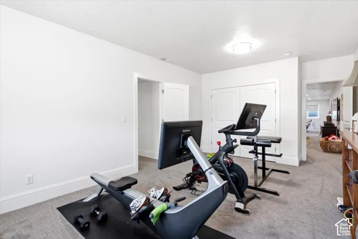 Spacious room with light gray carpeting and white painted walls