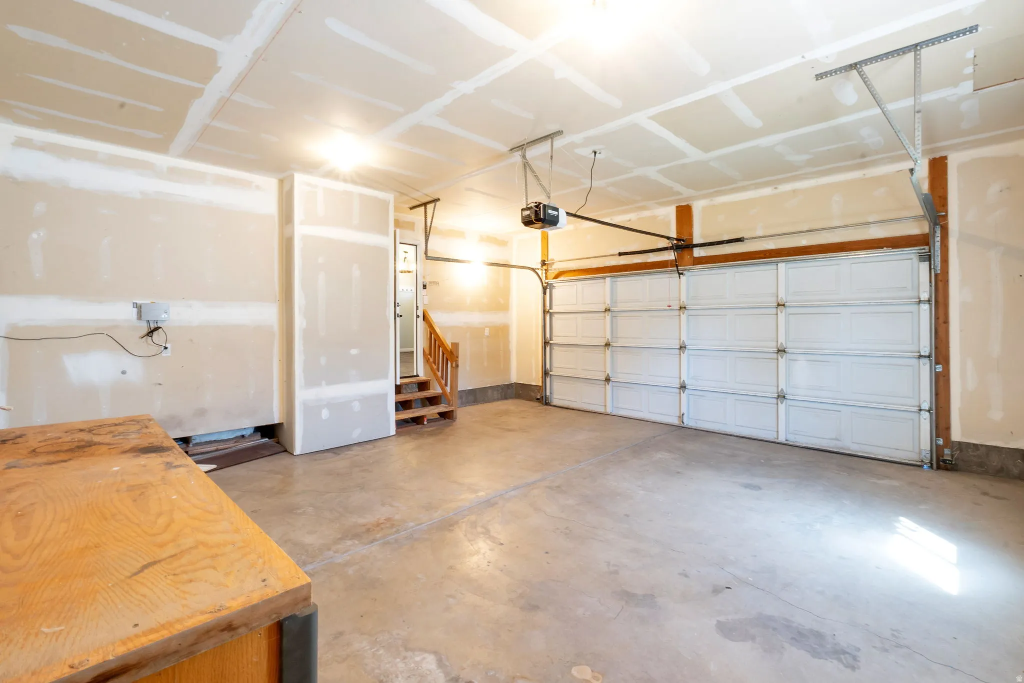 Spacious garage with a sectional overhead door and an automatic opener system