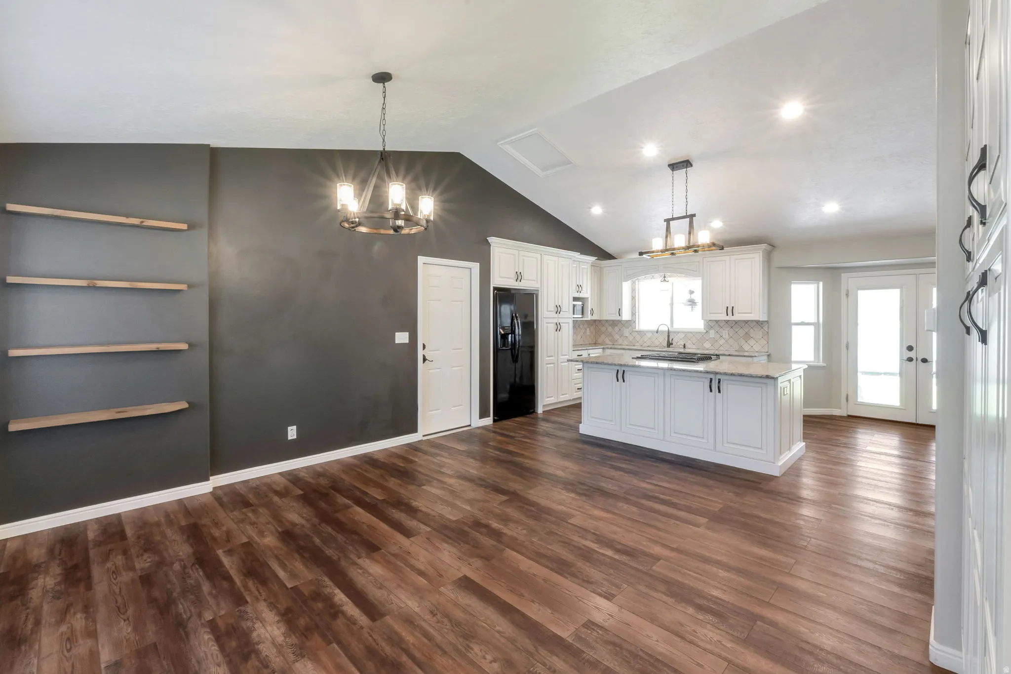 Open-concept kitchen and living area featuring wood-finish flooring