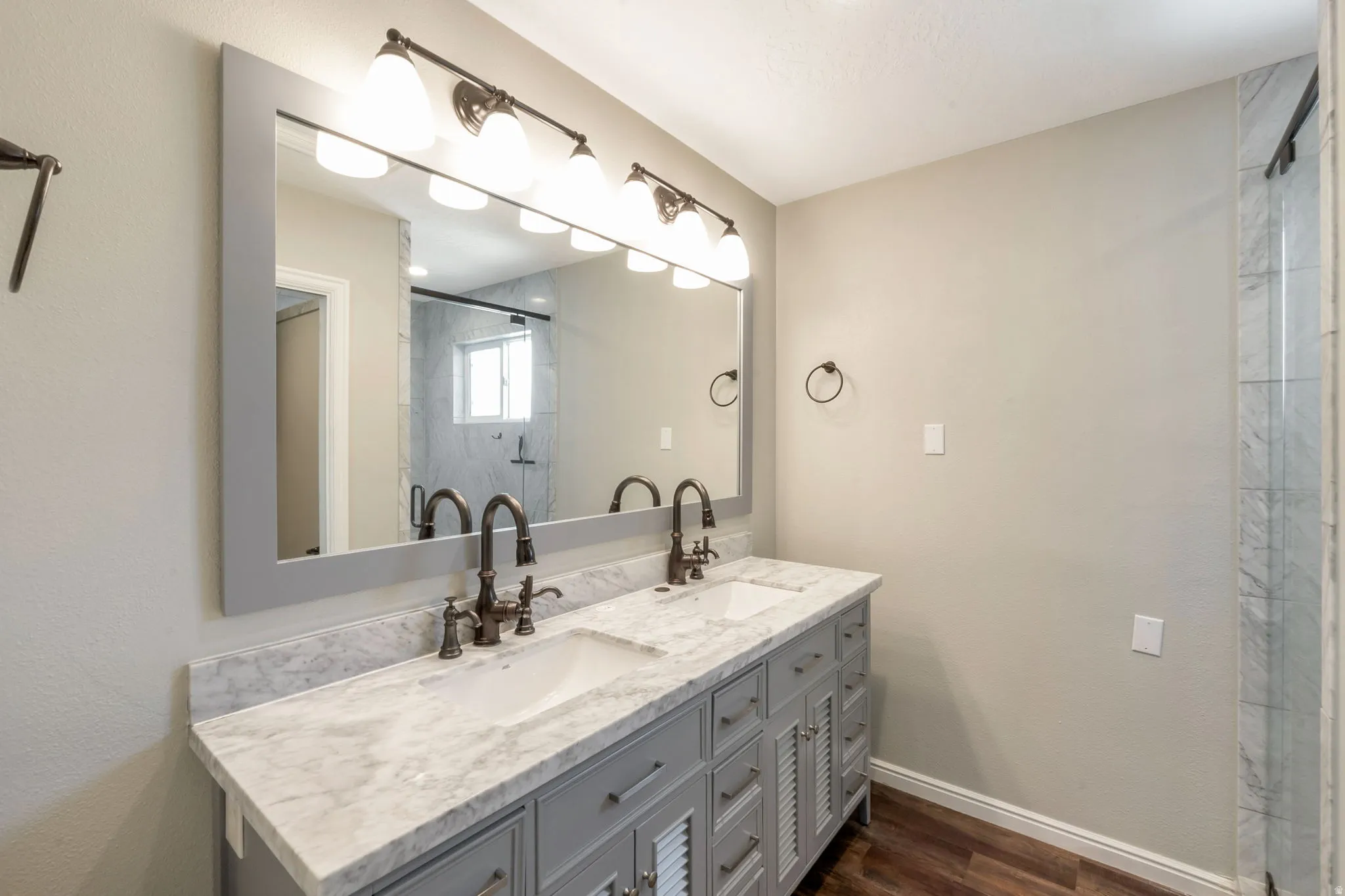 Double vanity with integrated sinks, a patterned countertop, and dark-bronze fixtures
