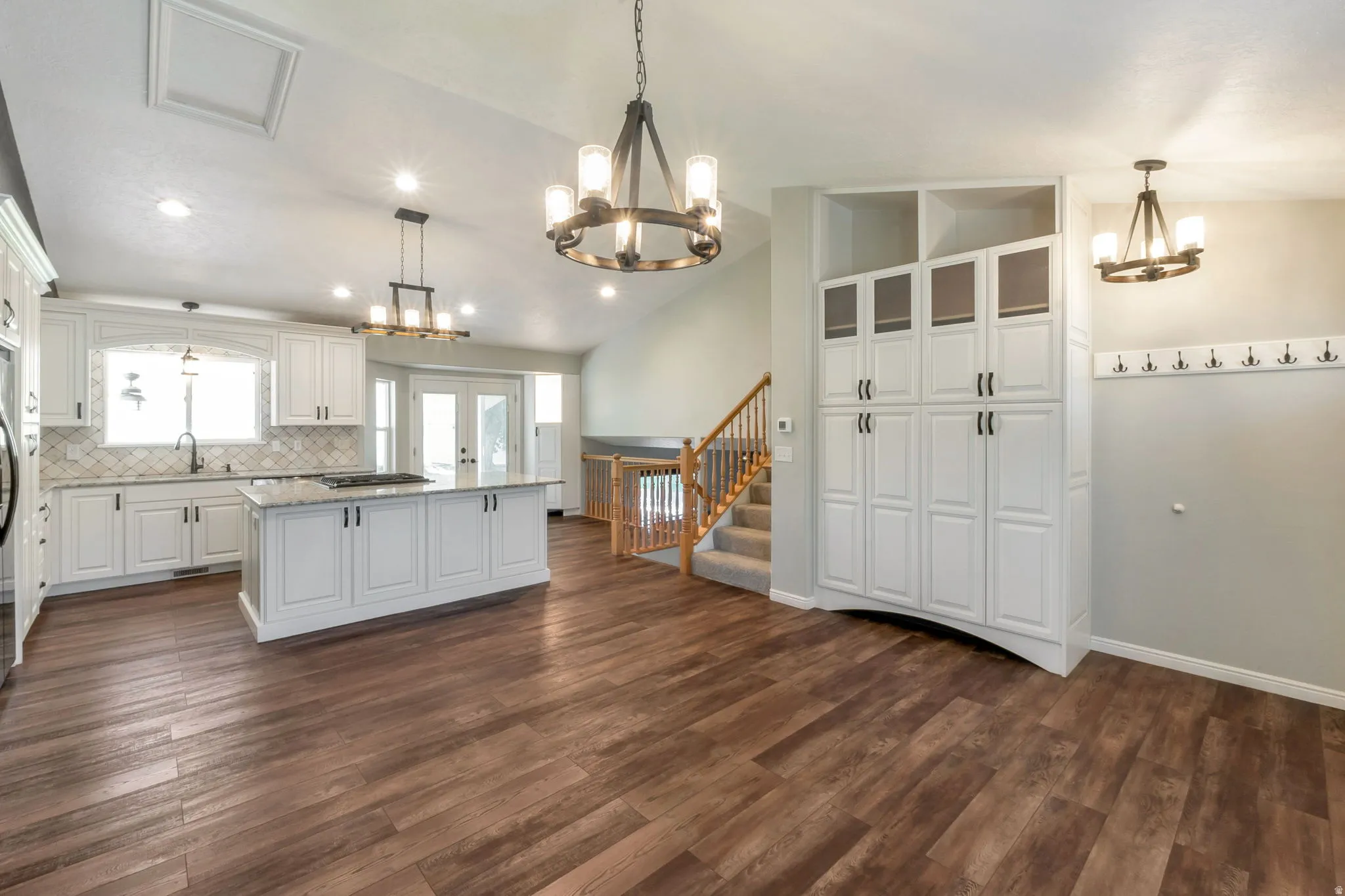 Open-concept kitchen and living area featuring wood-finish flooring