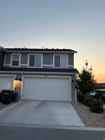 Two-story residence featuring a two-car garage with a concrete driveway