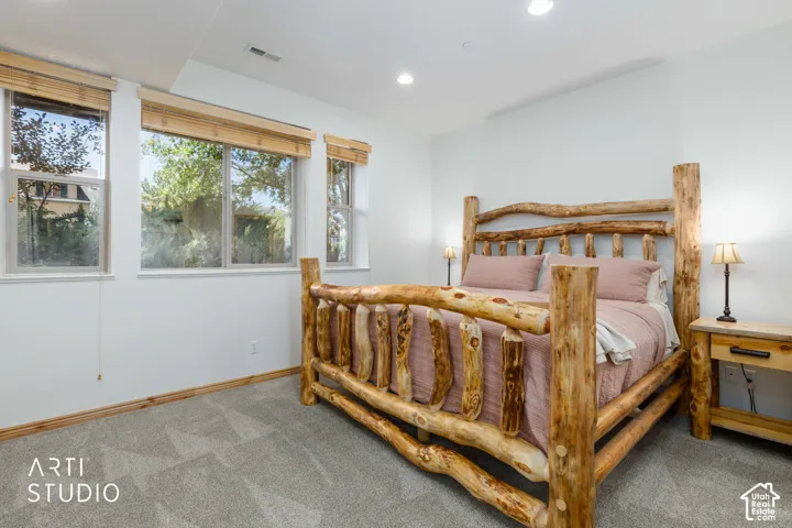 Primary bedroom with King size bed, with recessed lighting and multiple windows