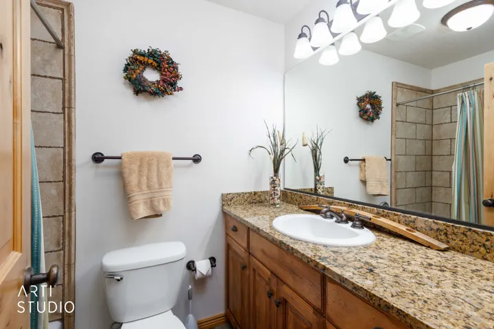 Bathroom featuring a vanity with a granite countertop, and full tob/shower combo.