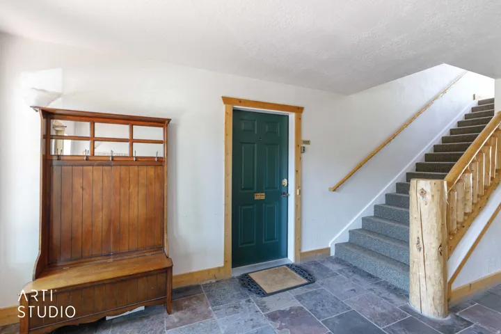 Entry foyer with slate tile flooring and white walls