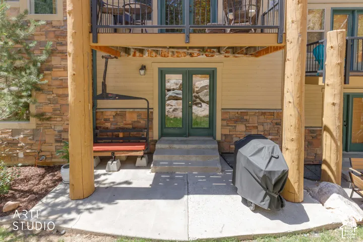 Back patio area featuring Iconic Timberline lift chair with cushion and Weber grill