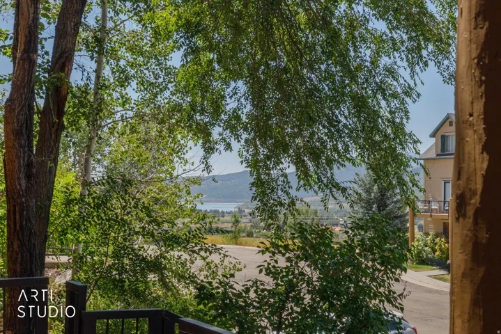 Mature trees frame  views of Pineview and snowbasin from the front porch