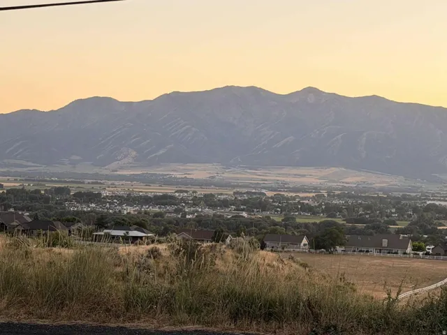 Mountain backdrop with expansive terrain and distant structures
