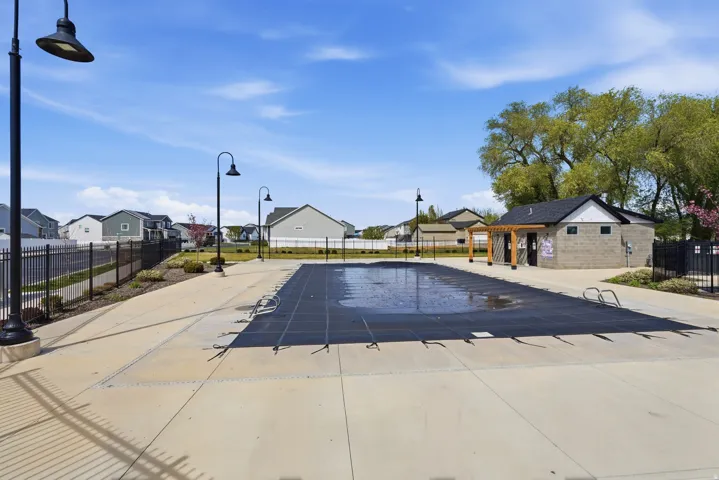 Expansive concrete pool deck surrounding a covered swimming pool