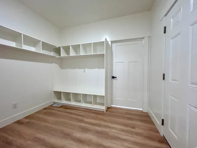 Built-in shelving and cubbies with wood-finish flooring