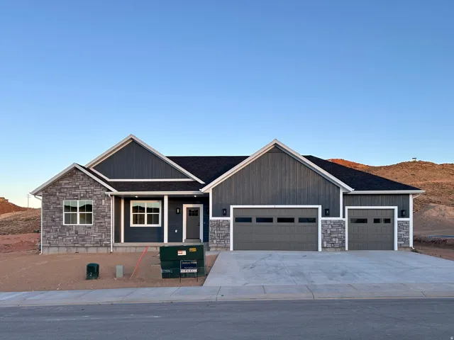 Contemporary ranch-style exterior featuring a striking gray and stone façade