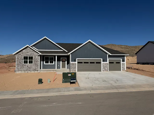 Contemporary ranch-style residence featuring a dark blue facade with white trim
