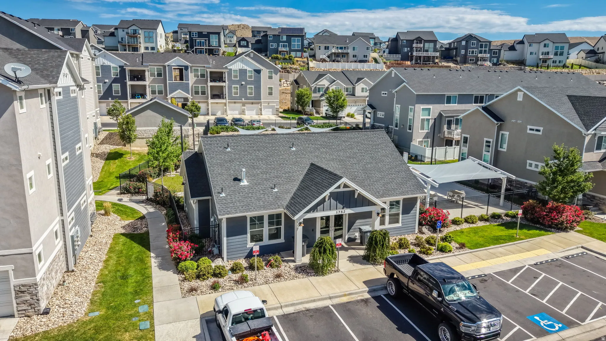 Modern-style community building featuring a dark gray shingle roof and light blue siding