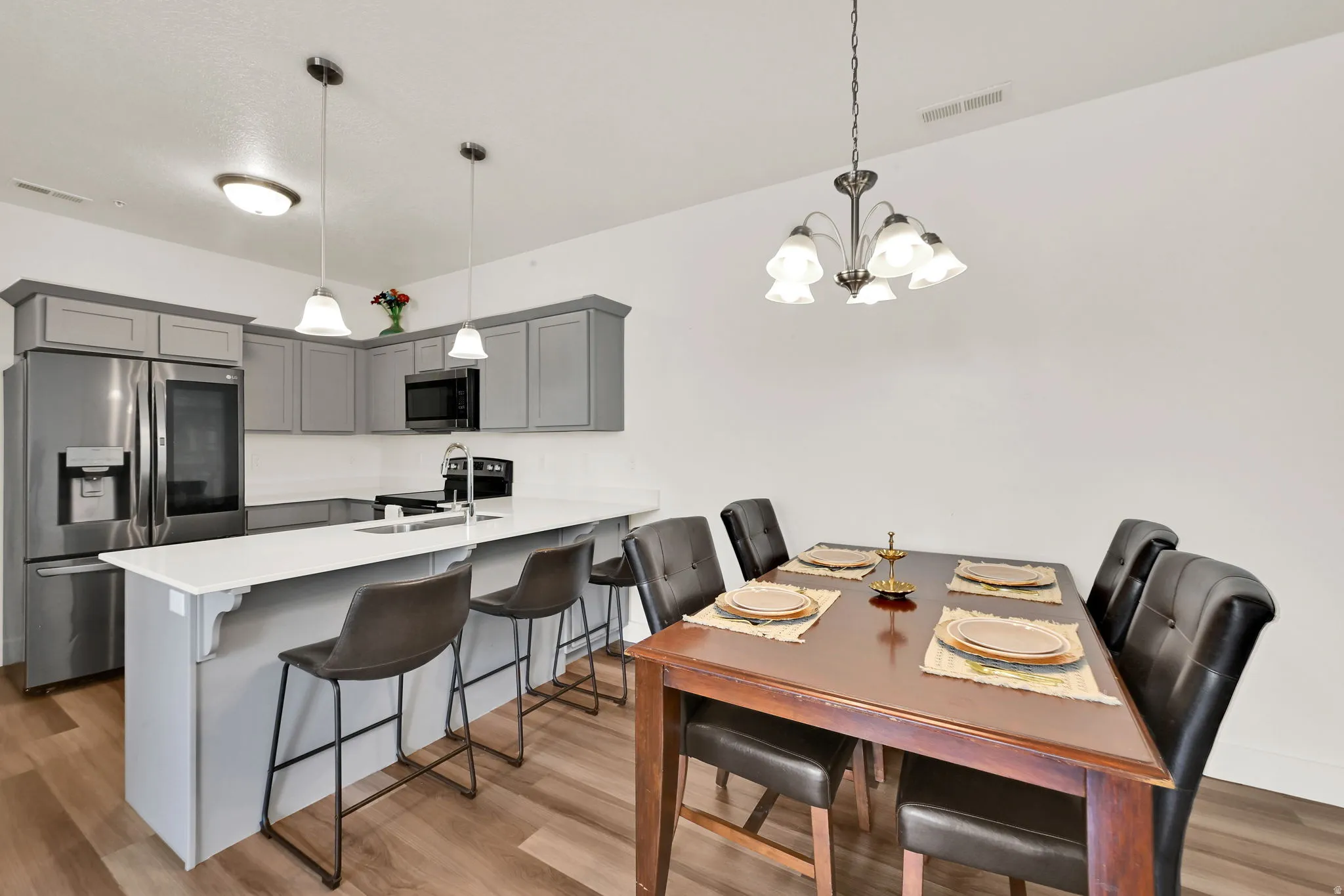 Open concept kitchen and dining area with wood-finish flooring