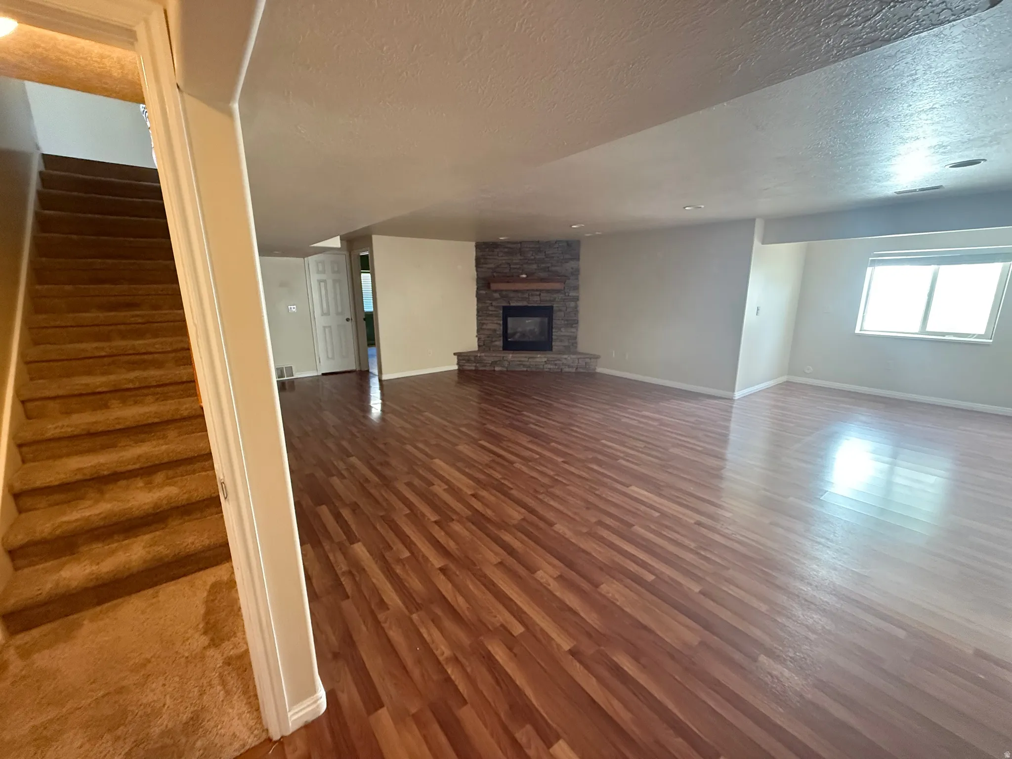 Spacious lower-level area featuring wood-finish flooring