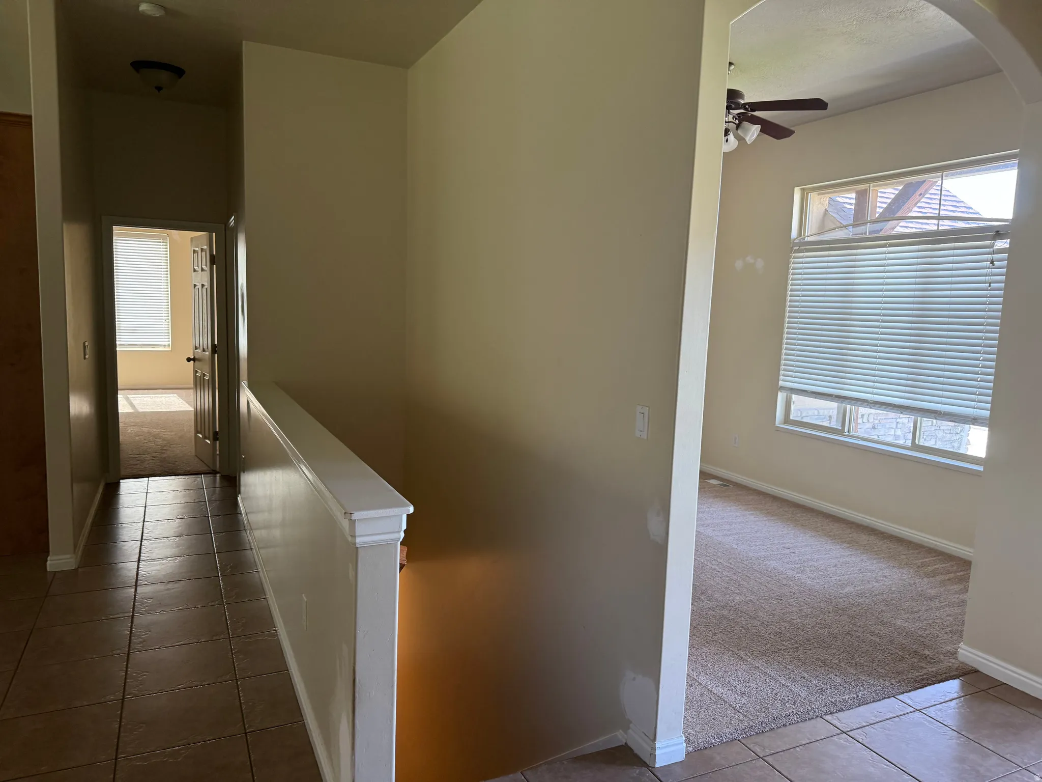 Entryway featuring tile flooring and a white painted banister