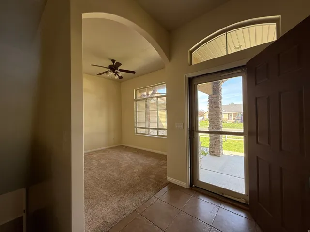 Tiled entryway with an arched transom window
