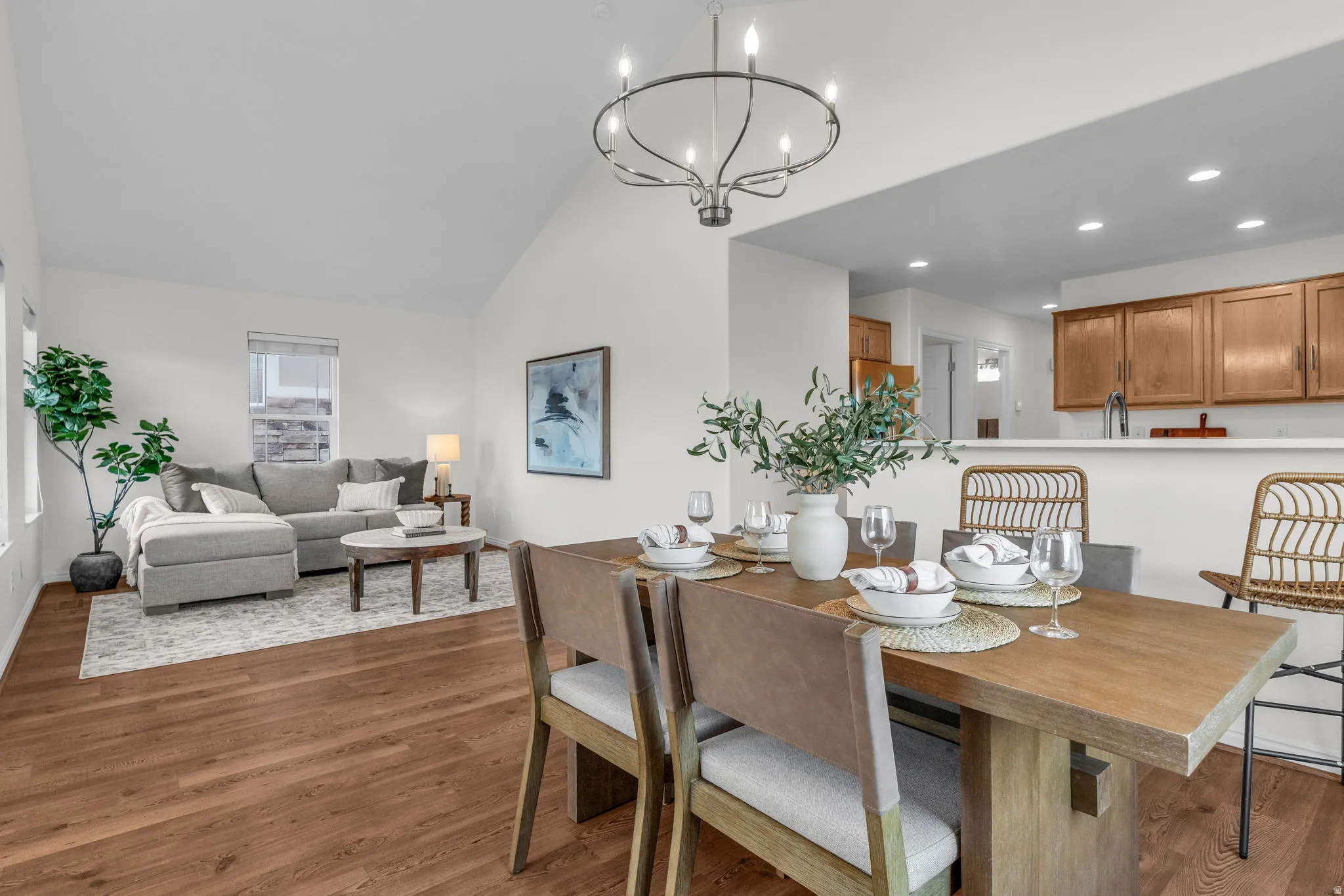 Dining area featuring a wood-finish table, a wrought iron chandelier, and wood-finish flooring