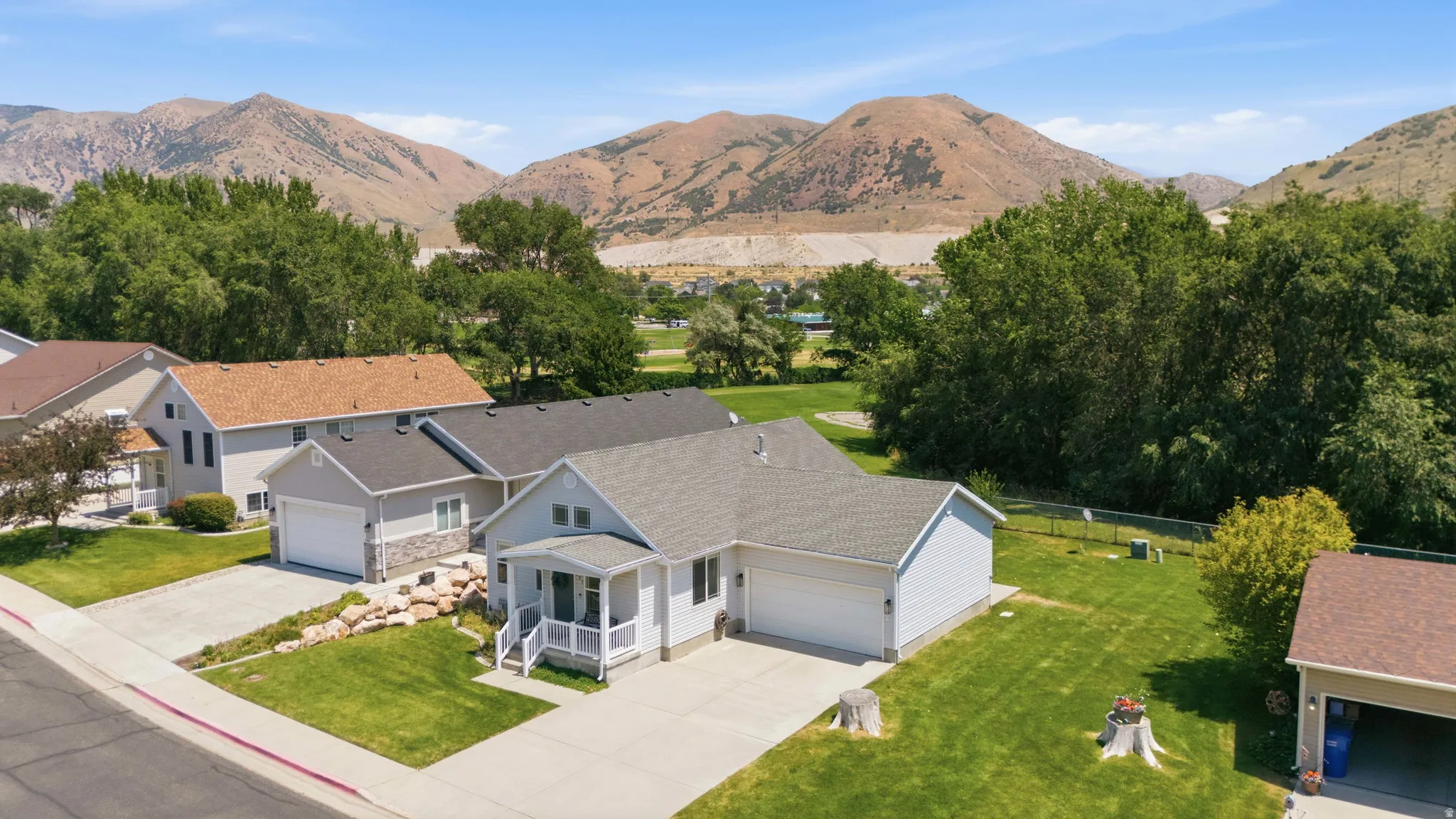 Ranch-style residence featuring light-colored siding and a covered front porch