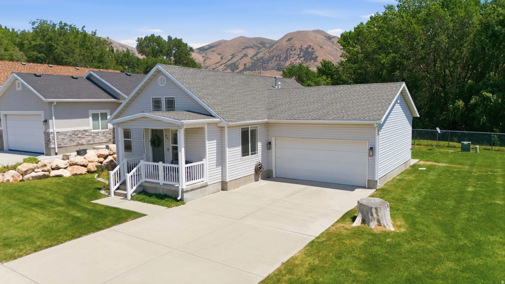 Siding exterior with a covered porch and white railing