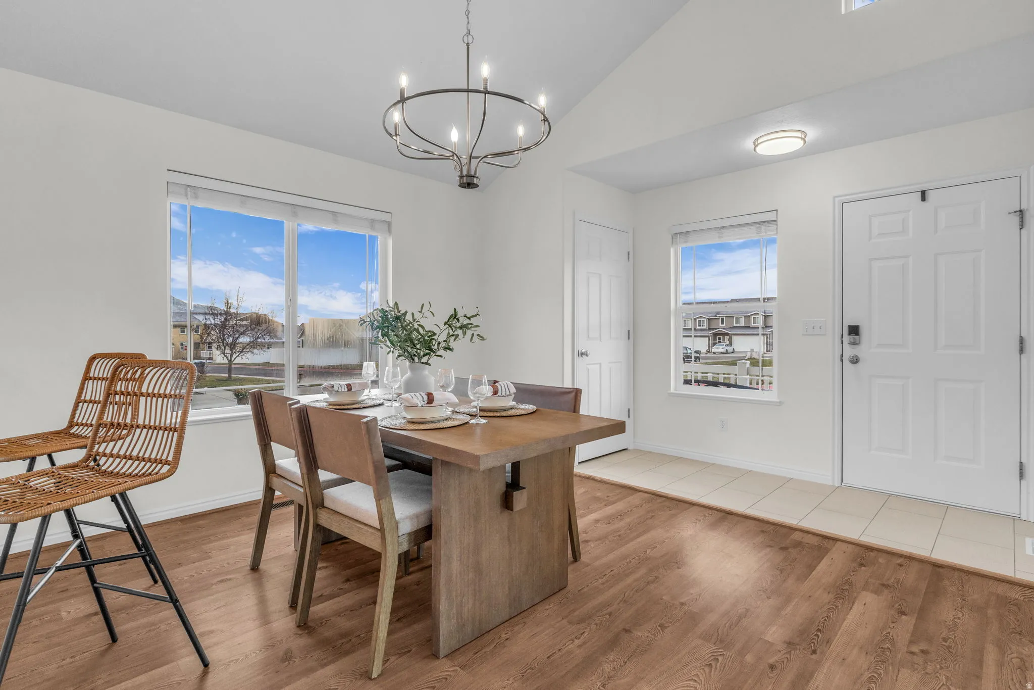 Dining area featuring wood-finish flooring and a contemporary chandelier