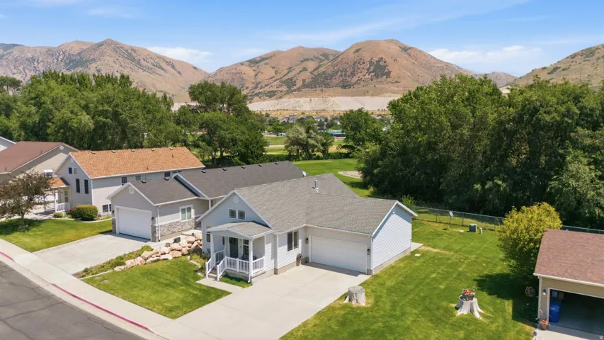 Ranch-style residence featuring light-colored siding and a covered front porch