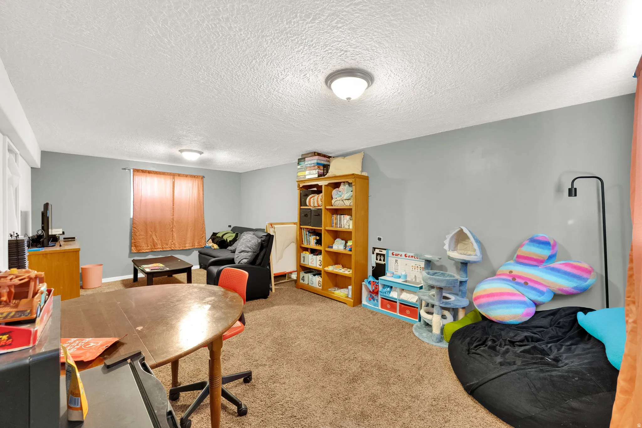 Carpeted room with light grey walls and white ceilings