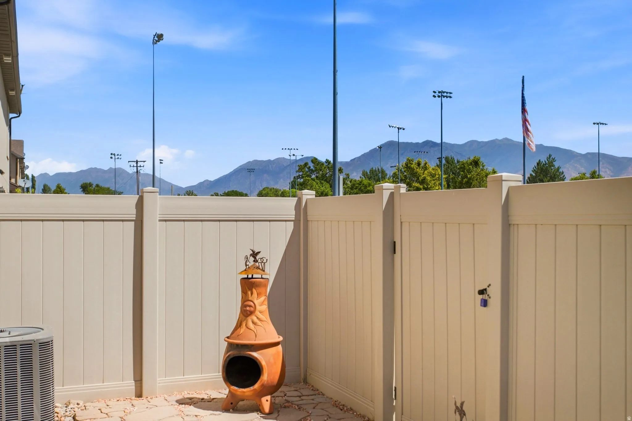 Private outdoor patio with a paved surface and perimeter fencing
