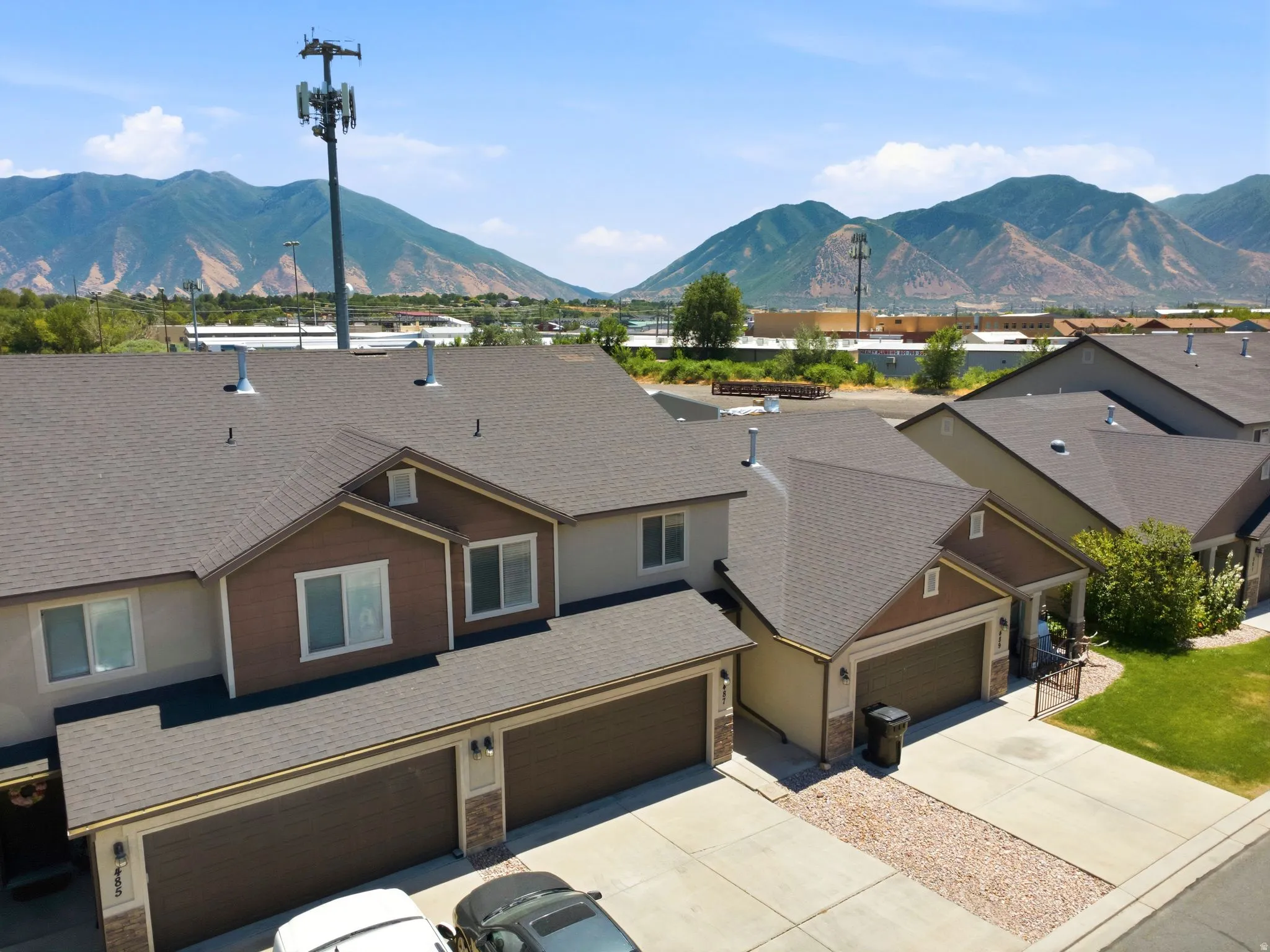 Townhome exteriors featuring two-car garages and complementary siding colors