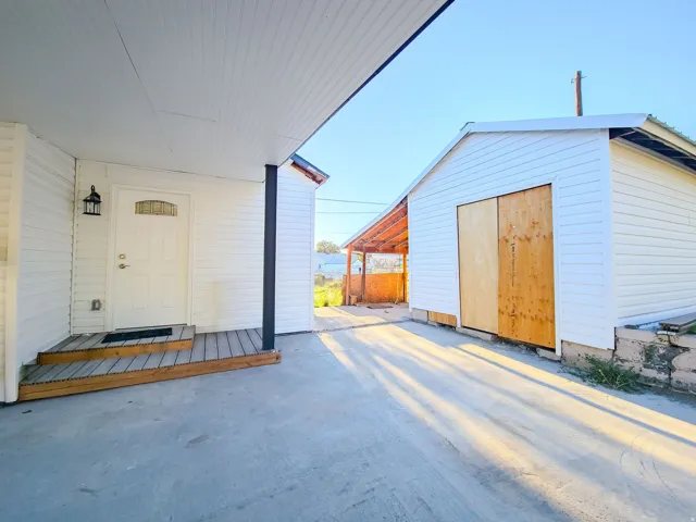 Covered entryway with plank-style decking, additional storage