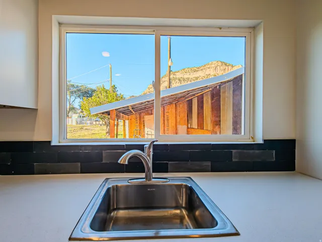 Stainless steel single-basin sink with a chrome faucet