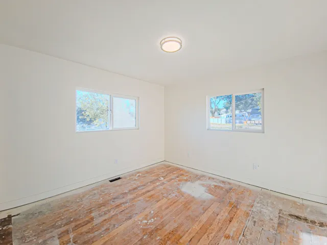 Neutral wall color with two windows and a flush mount ceiling light, new carpet on the way!