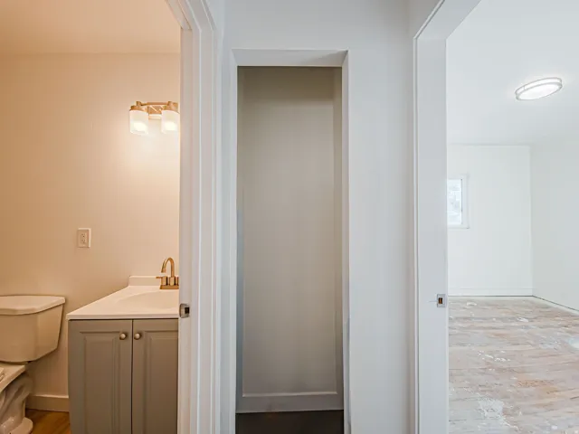 Bathroom vanity with a gold-finish faucet and dual-light fixture
