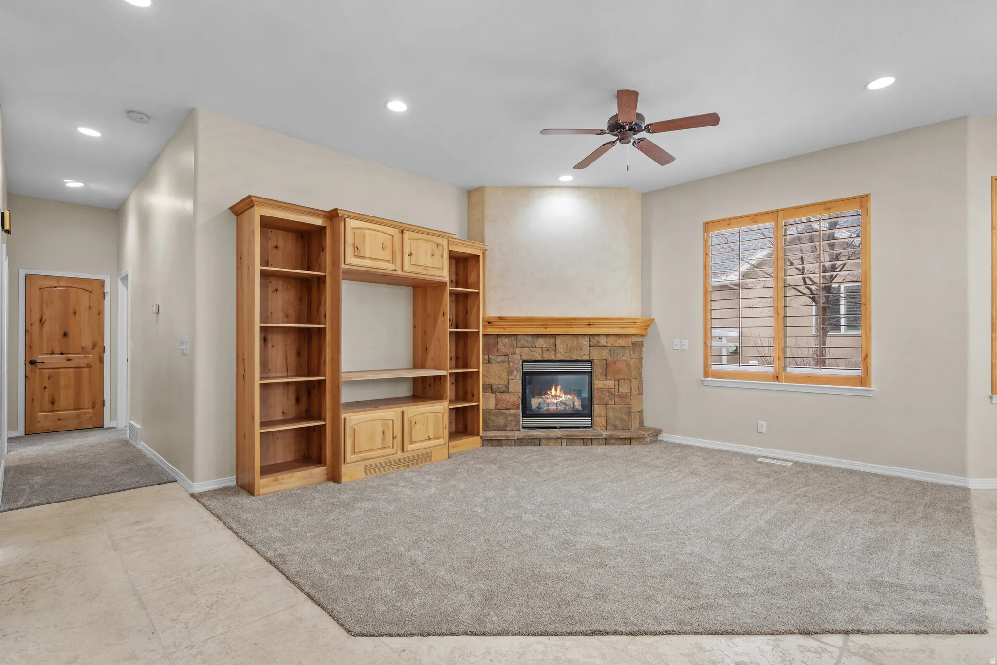 Corner fireplace with stone surround and wood mantel