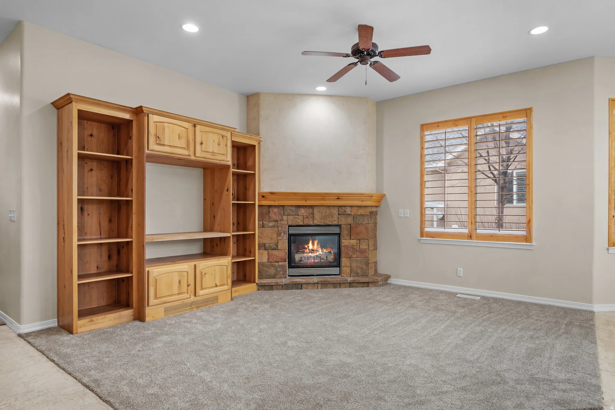 Corner fireplace with stone surround and wood mantel