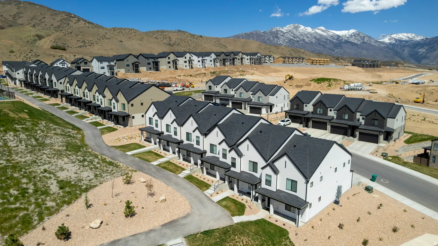 Modern townhome community featuring contemporary architectural styles and varied exterior finishes