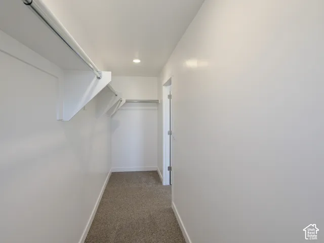 Recessed lighting, white walls, and light-toned carpet