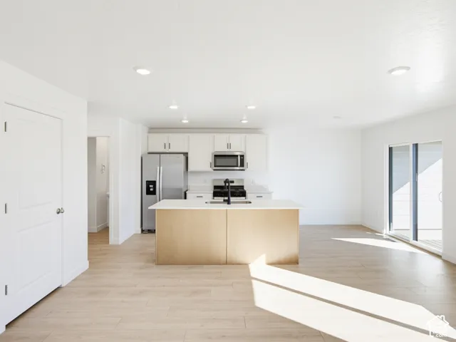 Open-concept living area with wood-finish flooring