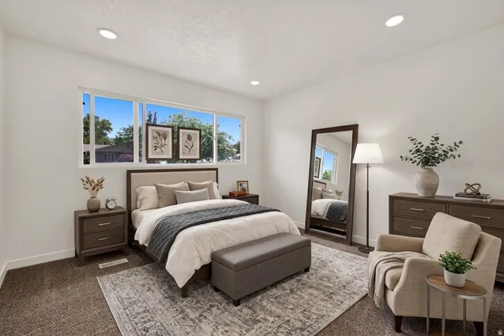 Spacious room featuring multiple horizontal windows, recessed lighting, and soft carpet flooring